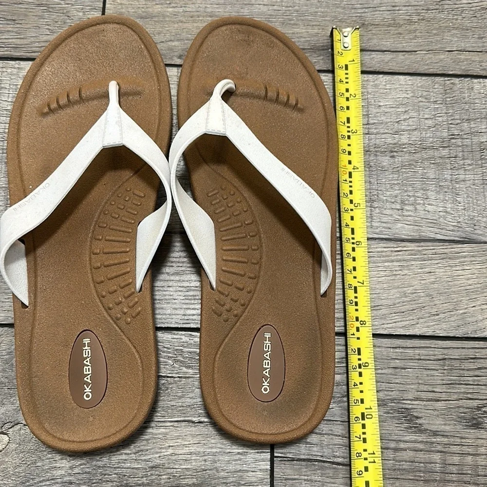 Okabashi flip flops with white straps and neutral color bottoms